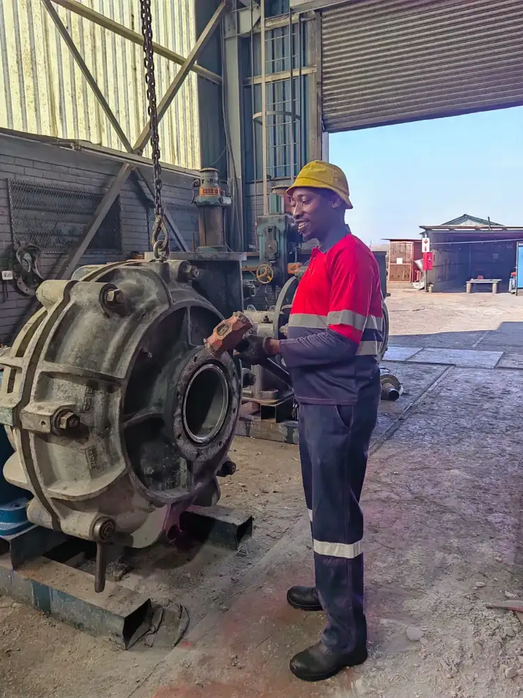 Gangaza technician inspecting a large industrial pump on site