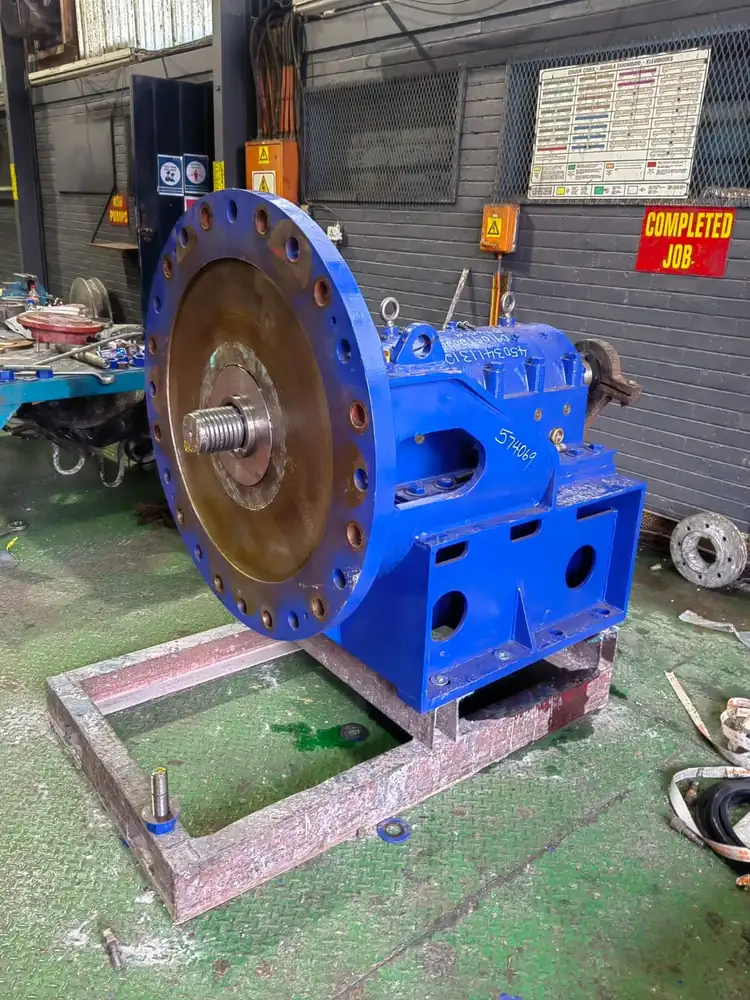 Refurbished blue pump on a workshop stand